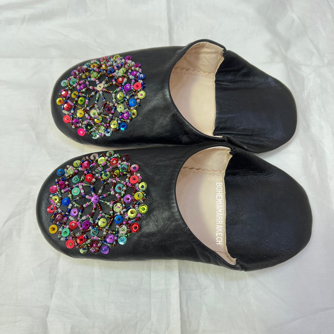 Handmade Moroccan leather babouche slippers with traditional pointed shape and hand-stitched edges.
