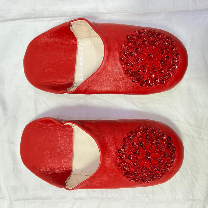 Artisan-made Moroccan babouche slippers with simple stitched details.