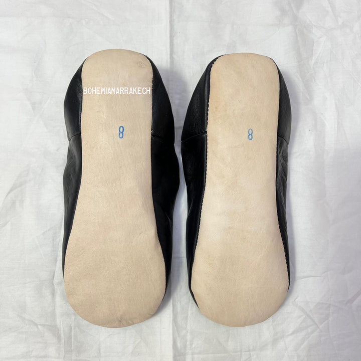Handmade Moroccan leather babouche slippers with traditional pointed shape and hand-stitched edges.