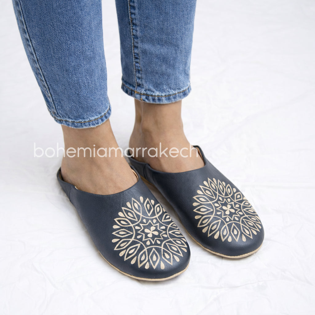 Handmade Moroccan babouche slippers in dark gray leather with hand-carved decorative design, crafted by artisans in Morocco.