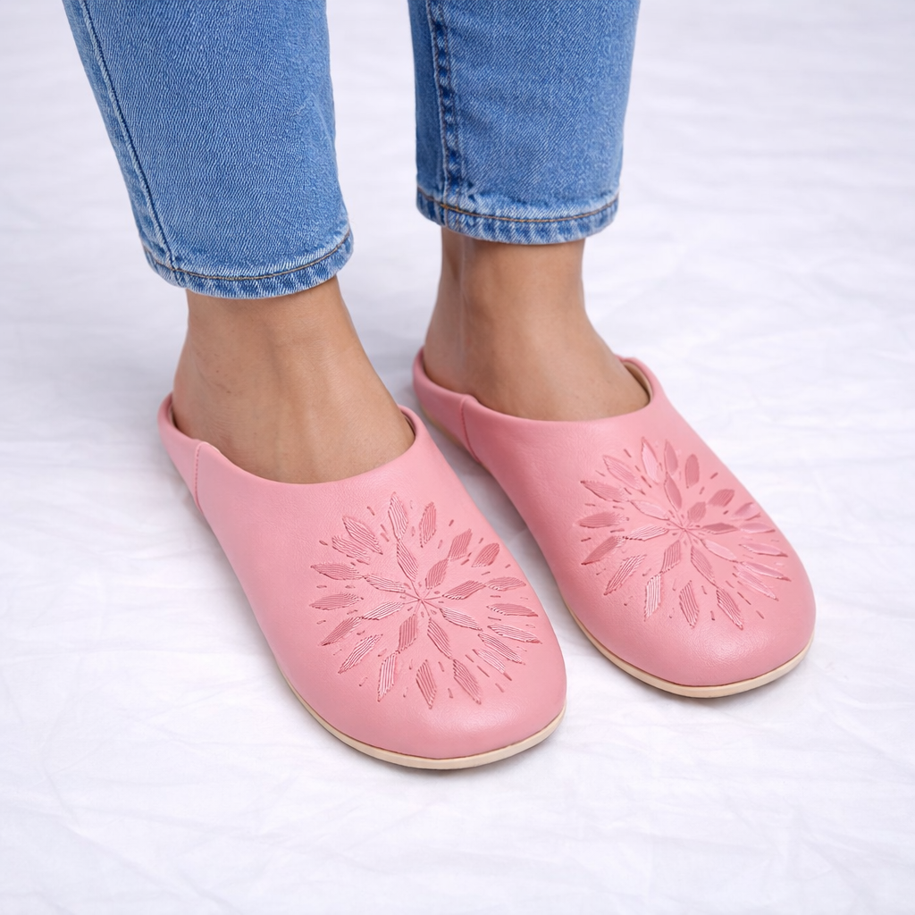 Fully hand-stitched Moroccan babouche slippers in soft pink leather with stitched floral design, handmade in Morocco.