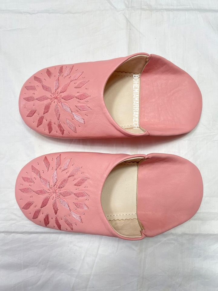 Fully hand-stitched Moroccan babouche slippers in soft pink leather with stitched floral design, handmade in Morocco.