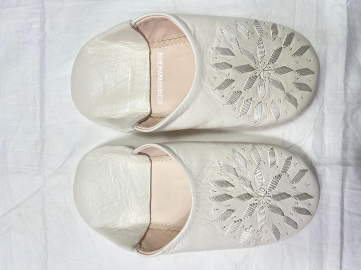 Hand-stitched ivory Moroccan leather babouche slippers with carved geometric design