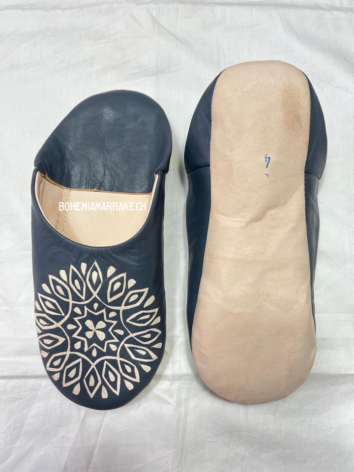 Handmade Moroccan babouche slippers in dark gray leather with hand-carved decorative design, crafted by artisans in Morocco.