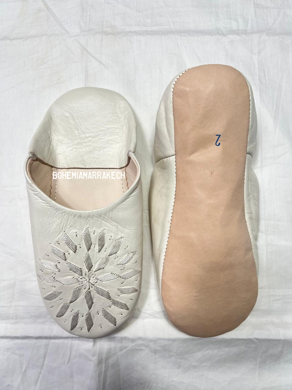 Hand-stitched ivory Moroccan leather babouche slippers with carved geometric design