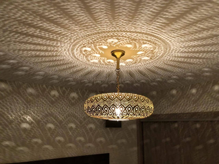 Decorative ceiling light fixture casting a pattern on the ceiling