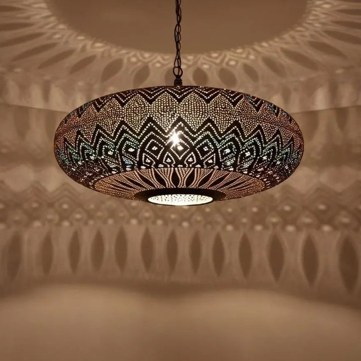Decorative pendant light casting shadows on a textured wall