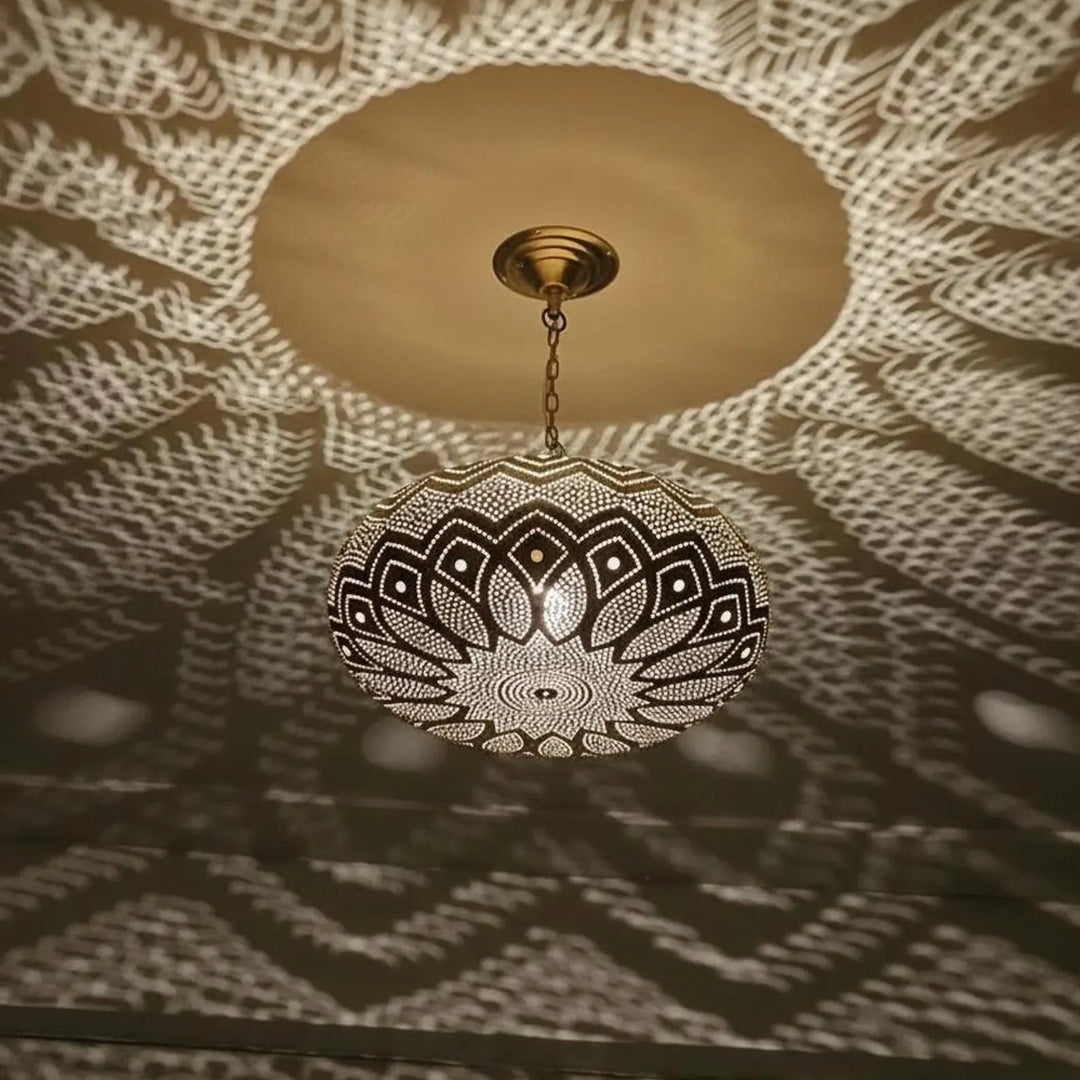 Decorative ceiling light fixture casting intricate shadows on a ceiling