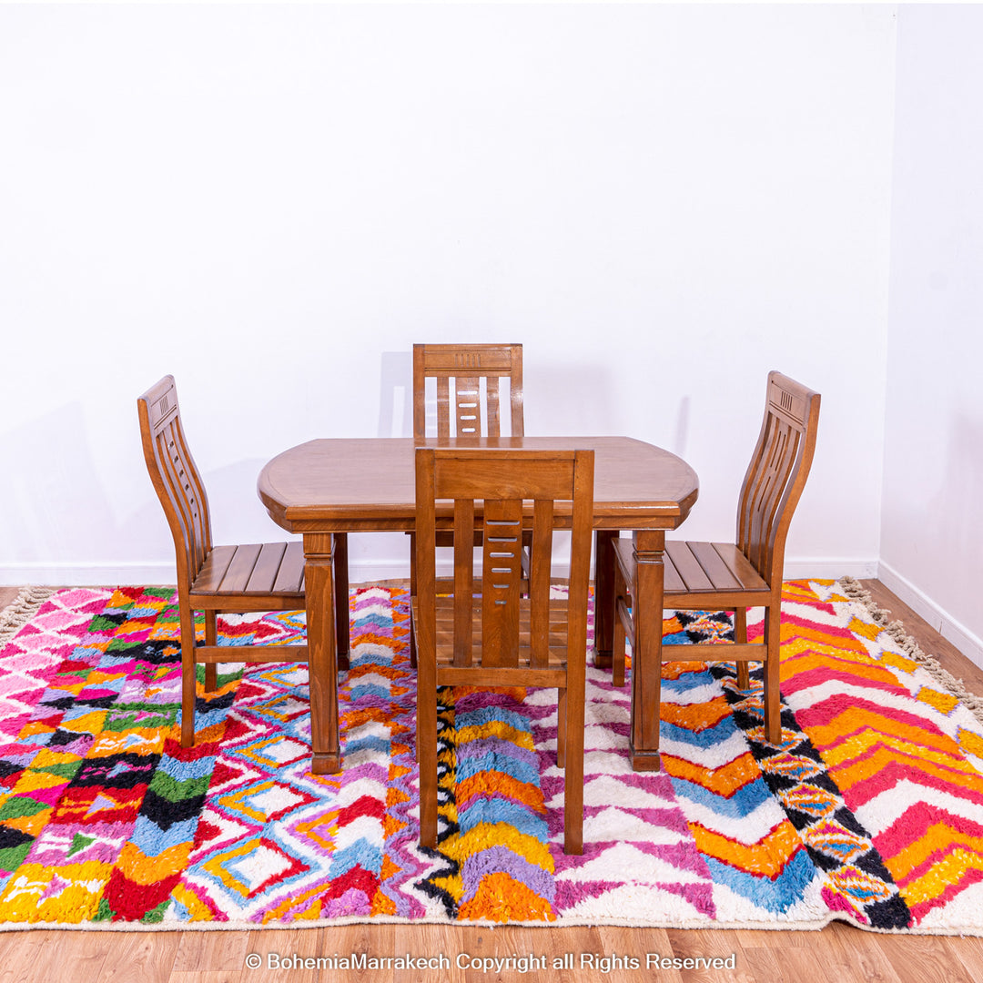Large colorful Moroccan rug with bold geometric Berber patterns in pink, orange, blue, and yellow