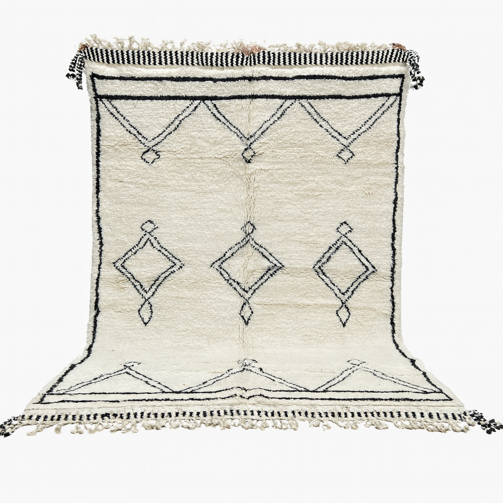 White rug with black geometric patterns on a white background