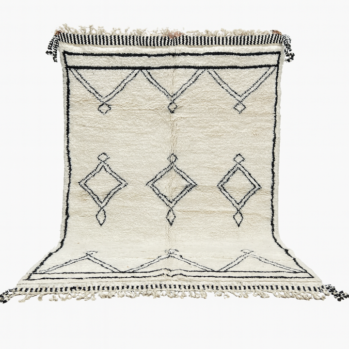 White rug with black geometric patterns on a white background