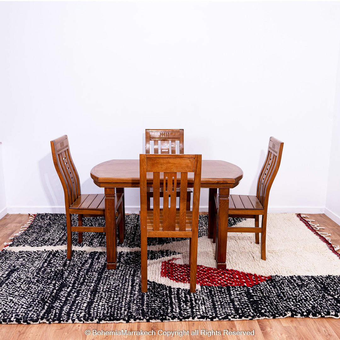 Handmade Moroccan runner rug featuring a traditional Berber symbol in red and black wool