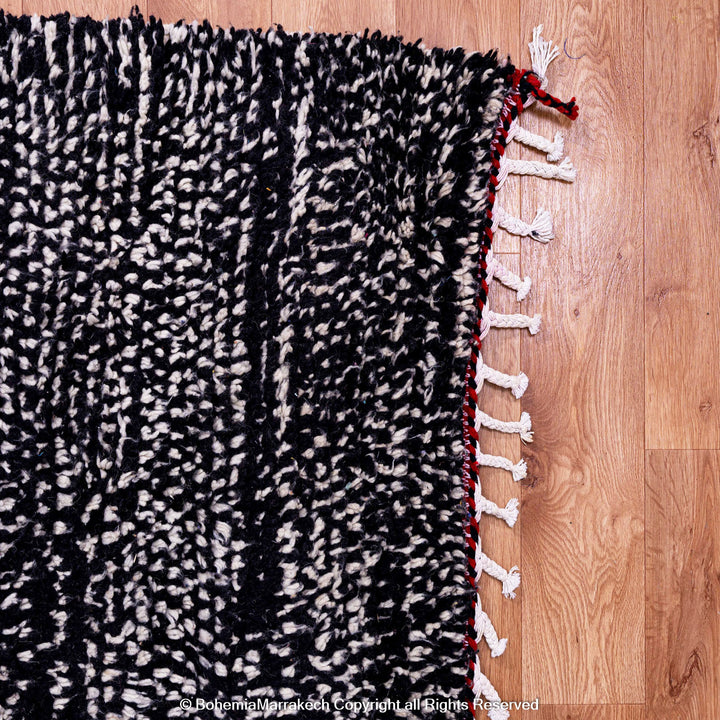 Handmade Moroccan runner rug featuring a traditional Berber symbol in red and black wool
