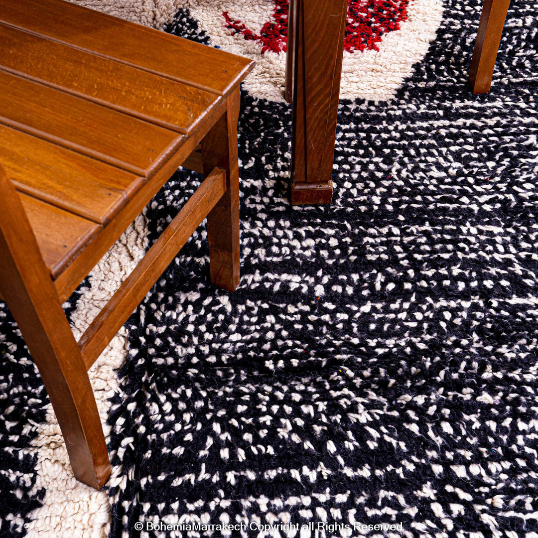 Handmade Moroccan runner rug featuring a traditional Berber symbol in red and black wool