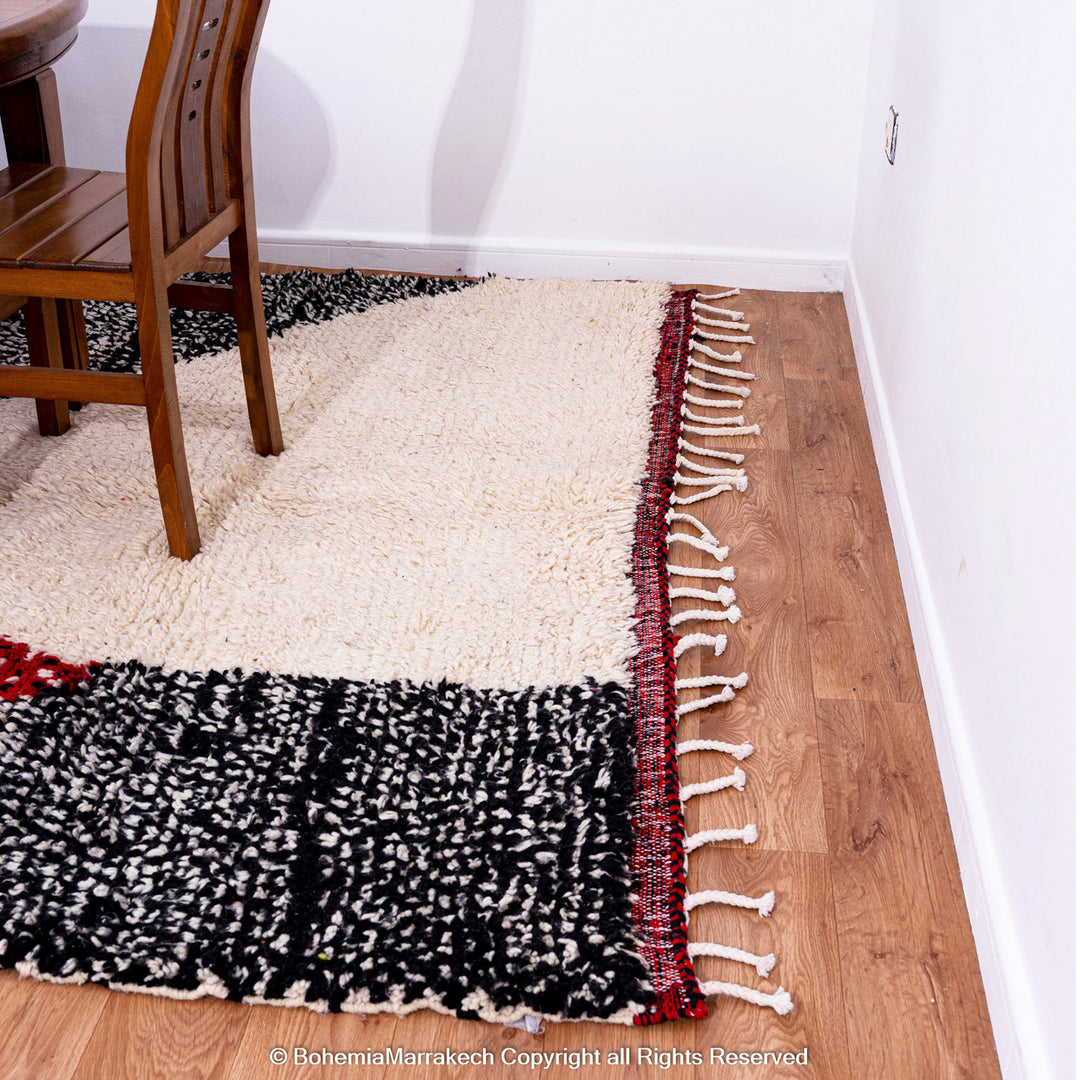 Handmade Moroccan runner rug featuring a traditional Berber symbol in red and black wool