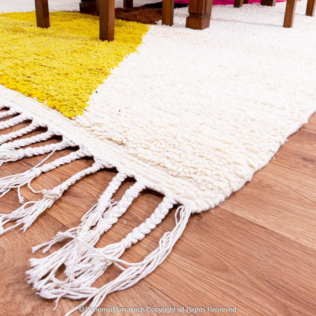 Handmade Moroccan shag rug with yellow and pink abstract hourglass design in Beni Ourain wool style