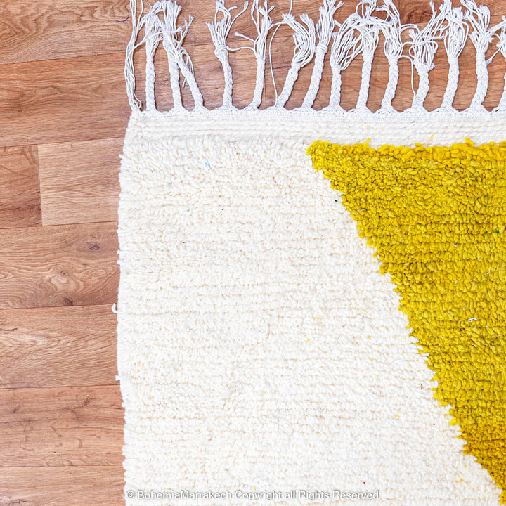 Handmade Moroccan shag rug with yellow and pink abstract hourglass design in Beni Ourain wool style