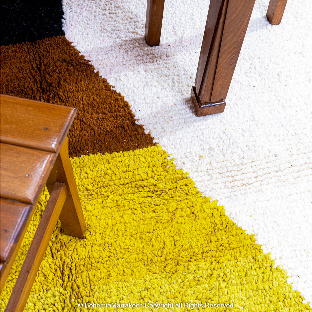 Handmade Moroccan shag rug with yellow and pink abstract hourglass design in Beni Ourain wool style