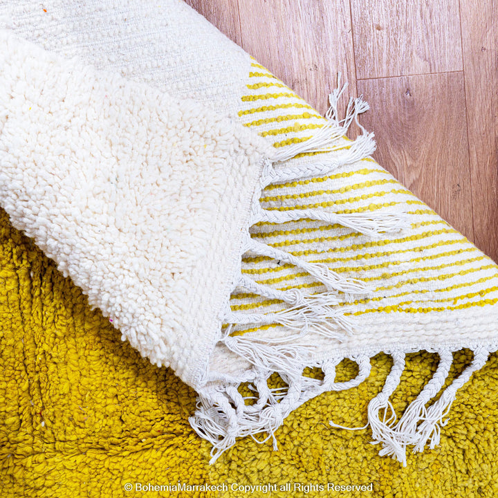 Handmade Moroccan shag rug with yellow and pink abstract hourglass design in Beni Ourain wool style