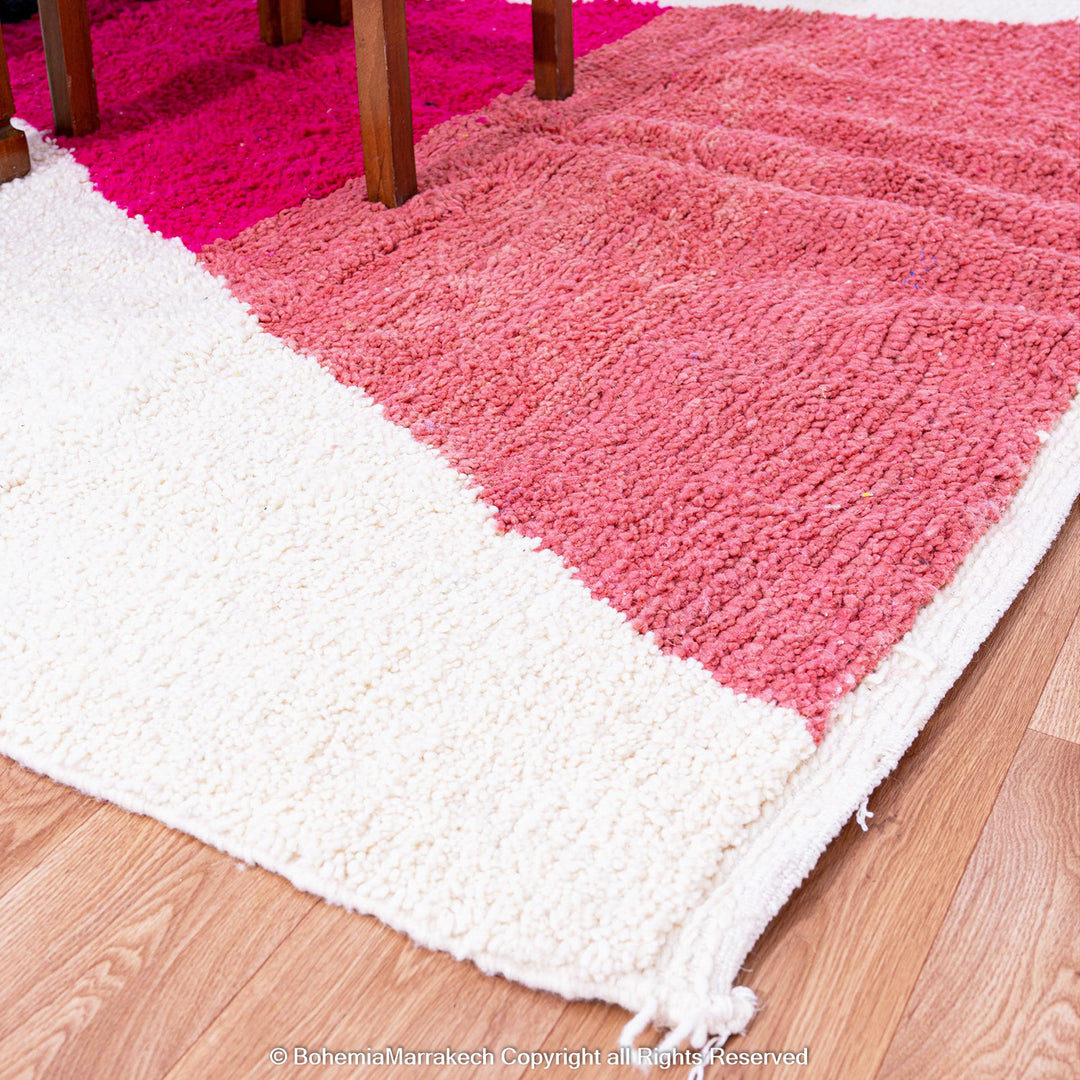 Handmade Moroccan shag rug with yellow and pink abstract hourglass design in Beni Ourain wool style