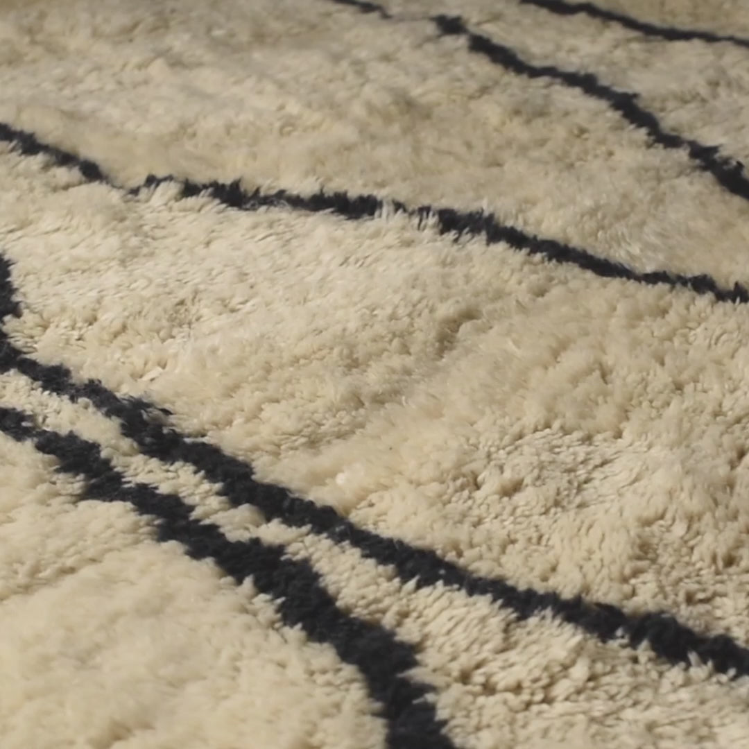 Moroccan Cream Wool Rug with Wavy Black Line Pattern