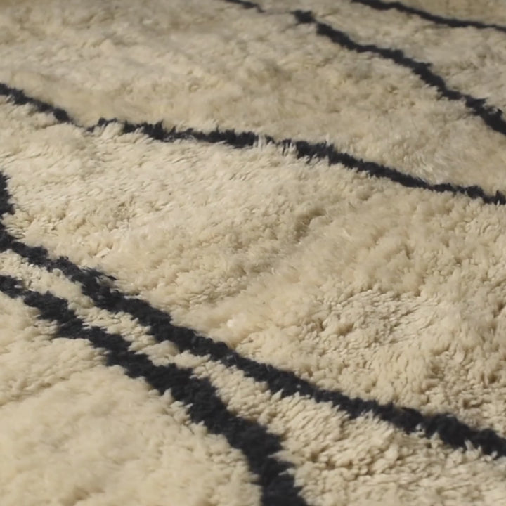 Moroccan Cream Wool Rug with Wavy Black Line Pattern