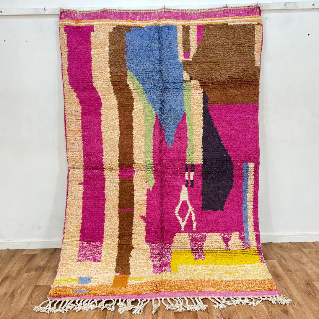 Vintage Moroccan wool rug with bold pink, brown, yellow and blue geometric Berber patterns, handmade tribal carpet from Morocco