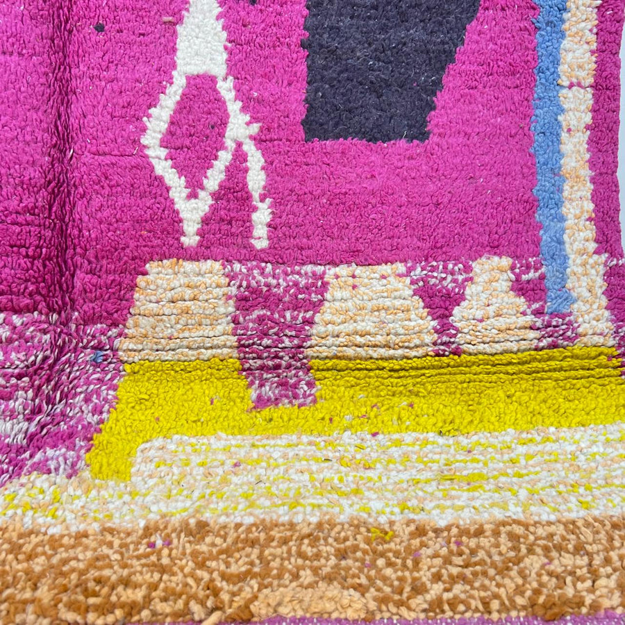 Vintage Moroccan wool rug with bold pink, brown, yellow and blue geometric Berber patterns, handmade tribal carpet from Morocco