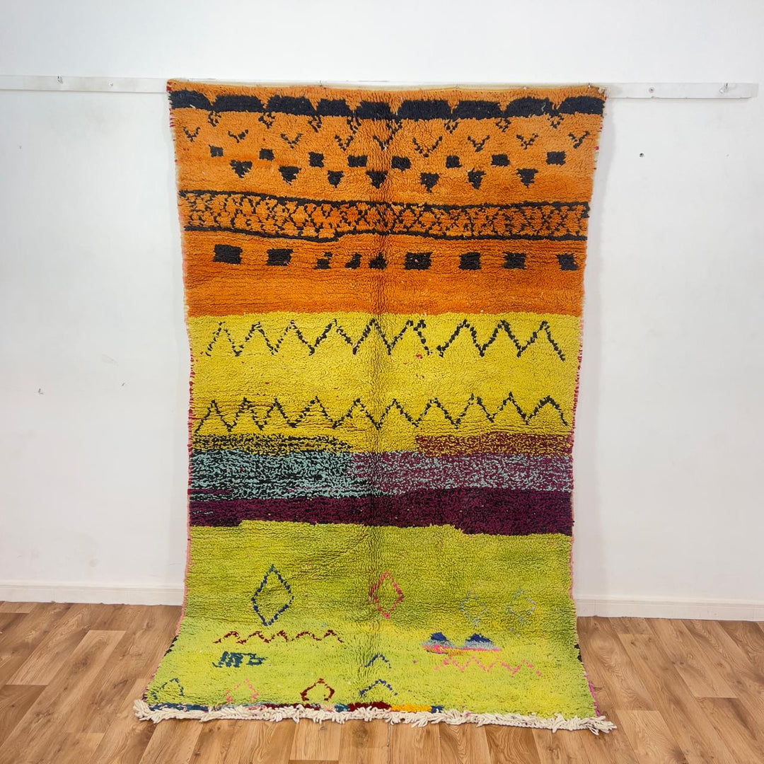 small vintage moroccan wool rug with yellow orange green stripes and berber tribal patterns handmade shag rug
