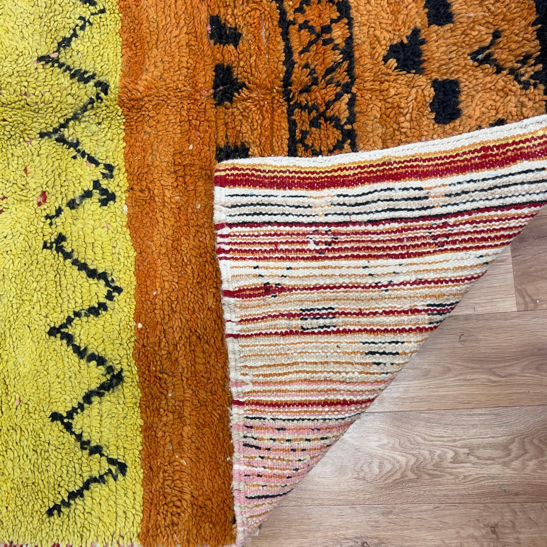 small vintage moroccan wool rug with yellow orange green stripes and berber tribal patterns handmade shag rug