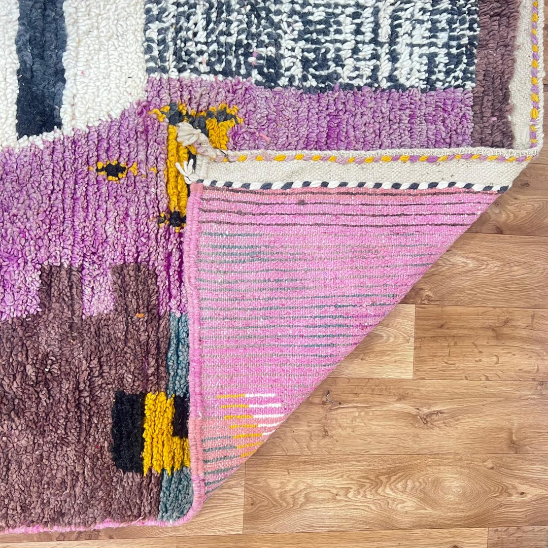 Vintage Moroccan wool rug with abstract Berber geometric motifs in mustard yellow, blue, lilac and ivory, handwoven in Morocco