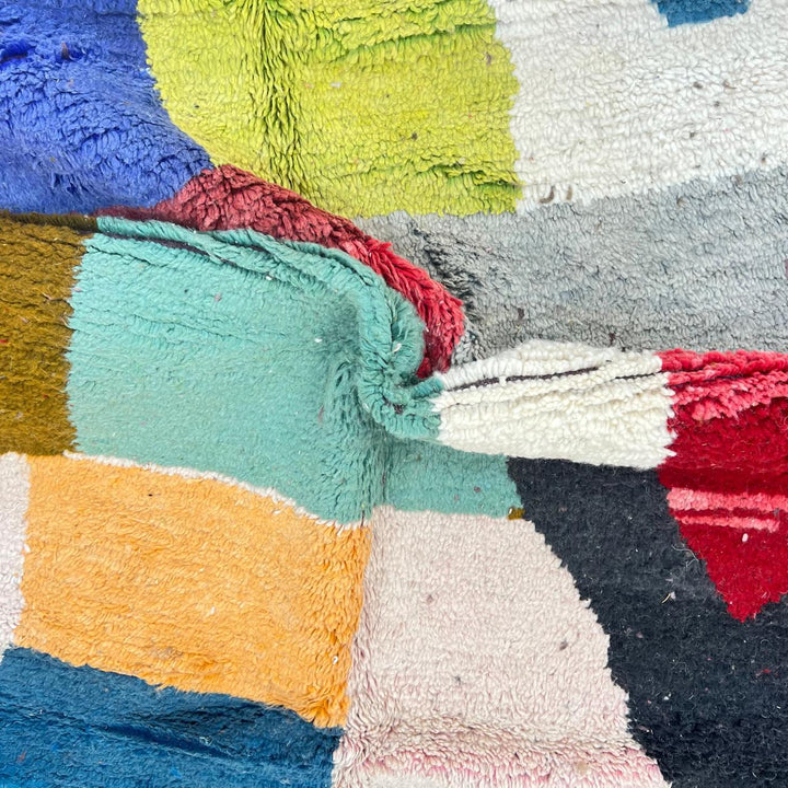 Vintage Moroccan Wool Rug BM168 – handmade geometric color block Moroccan rug in red, blue, and mustard tones (250 × 143 cm).