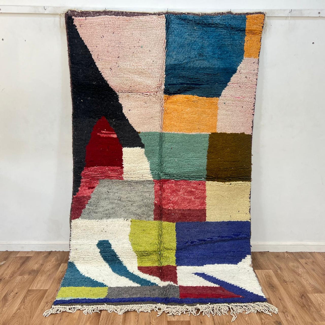 Vintage Moroccan Wool Rug BM168 – handmade geometric color block Moroccan rug in red, blue, and mustard tones (250 × 143 cm).