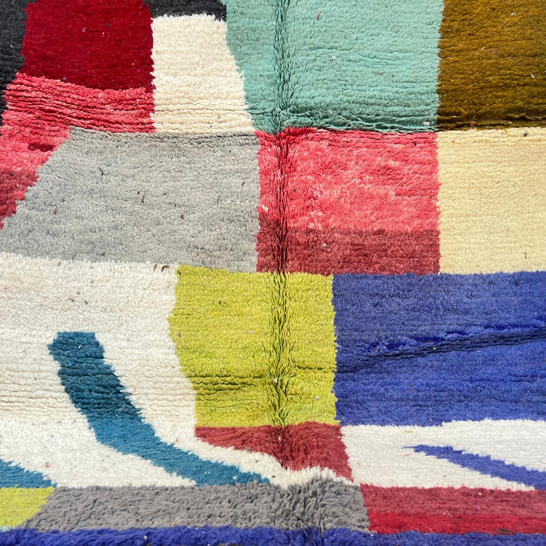 Vintage Moroccan Wool Rug BM168 – handmade geometric color block Moroccan rug in red, blue, and mustard tones (250 × 143 cm).