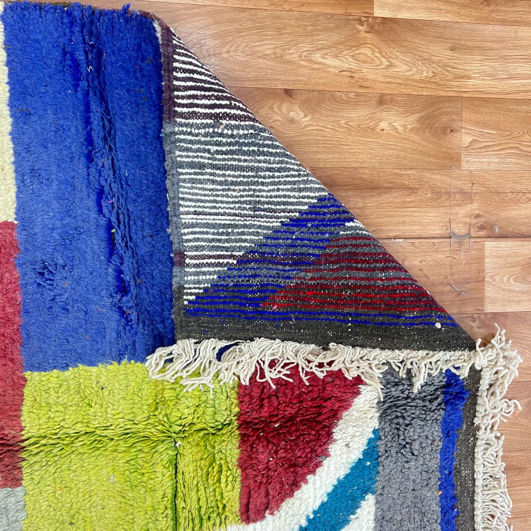 Vintage Moroccan Wool Rug BM168 – handmade geometric color block Moroccan rug in red, blue, and mustard tones (250 × 143 cm).