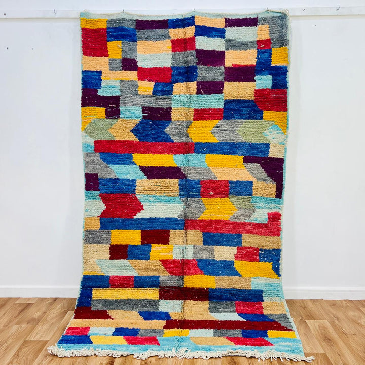 Colorful vintage Moroccan wool rug 664 handmade Berber with geometric blocks in blue, red, and yellow.