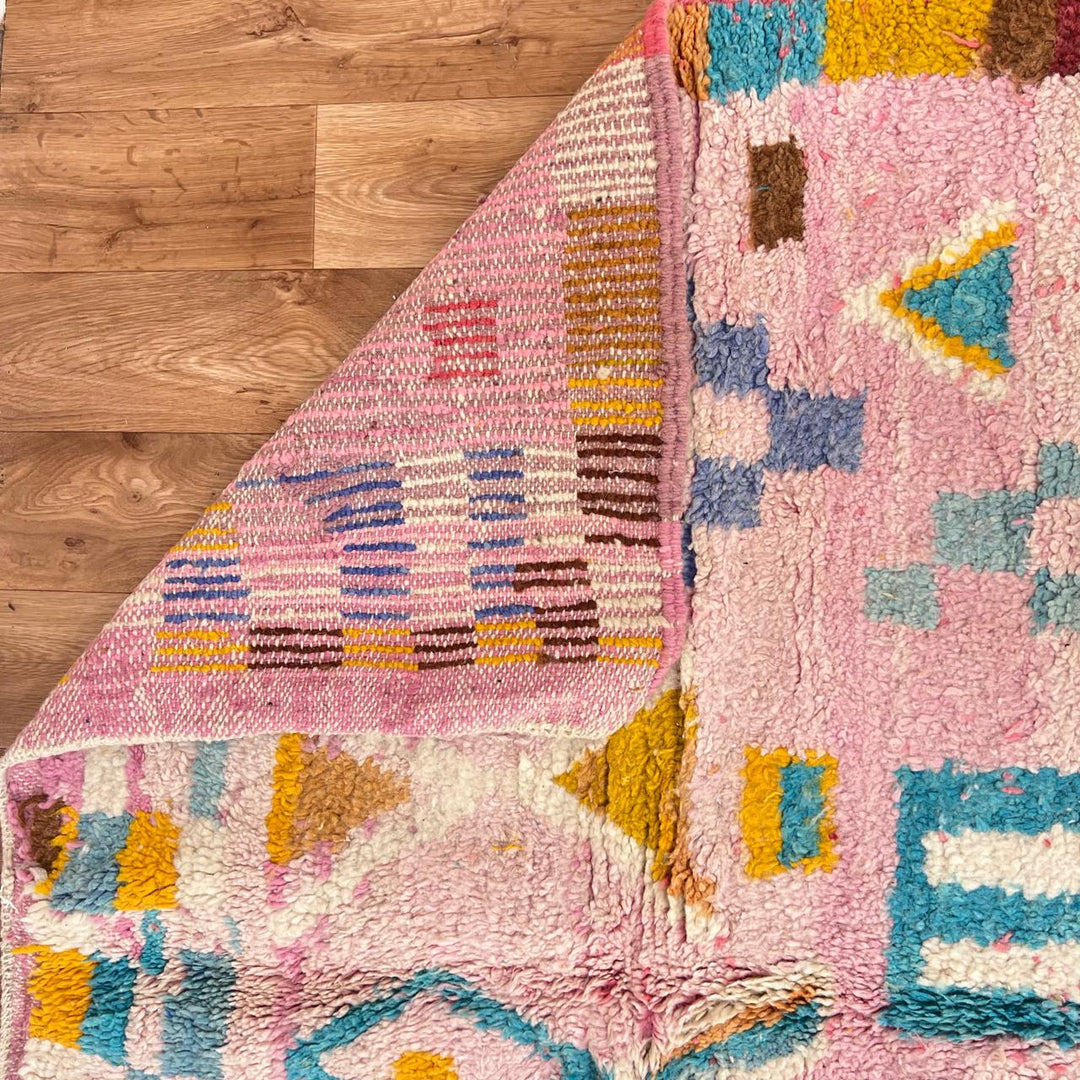 Vintage Moroccan wool rug 202 – handmade Berber rug with pastel pink, yellow, and blue geometric patterns (236 × 160 cm).