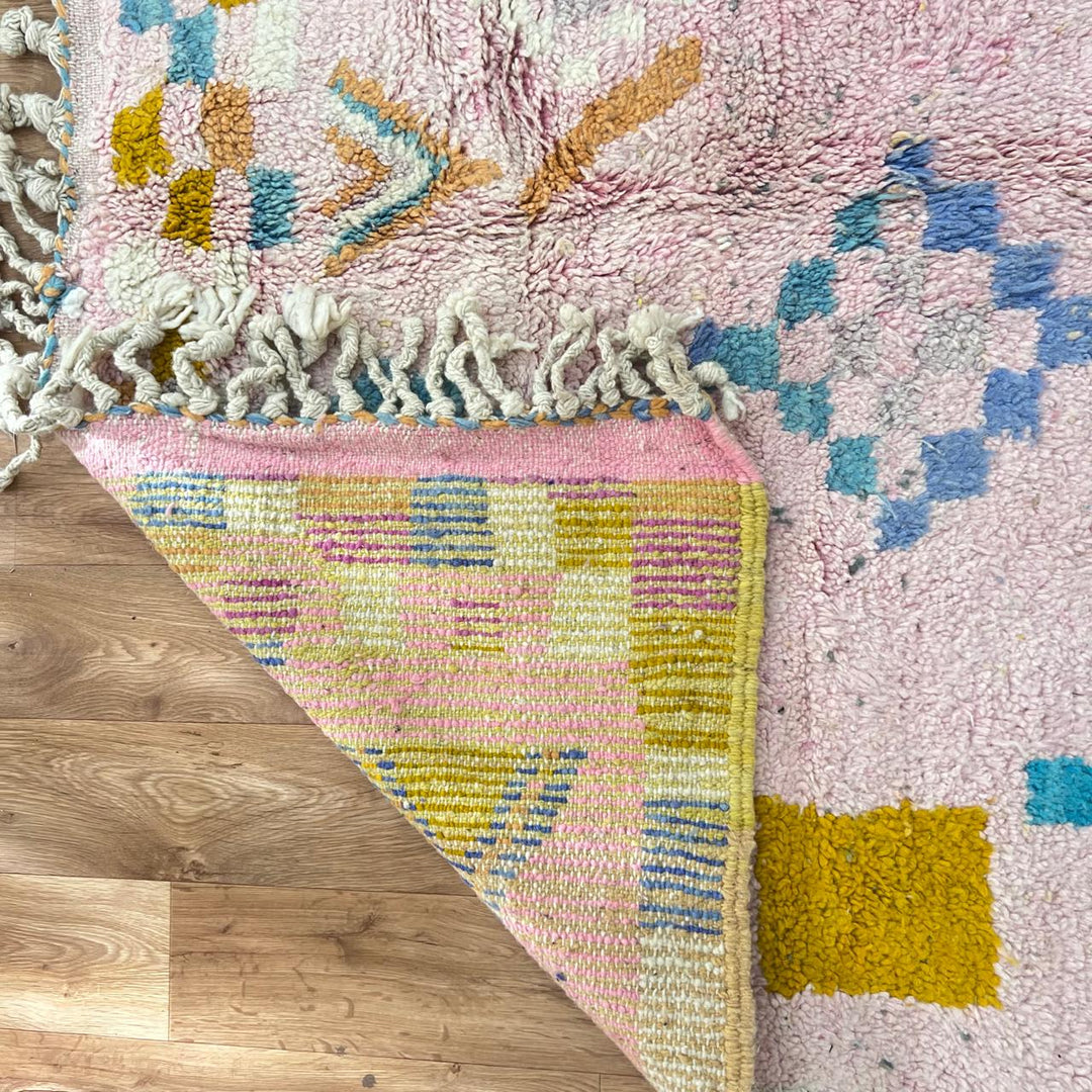Vintage Moroccan wool rug 202 – handmade Berber rug with pastel pink, yellow, and blue geometric patterns (236 × 160 cm).