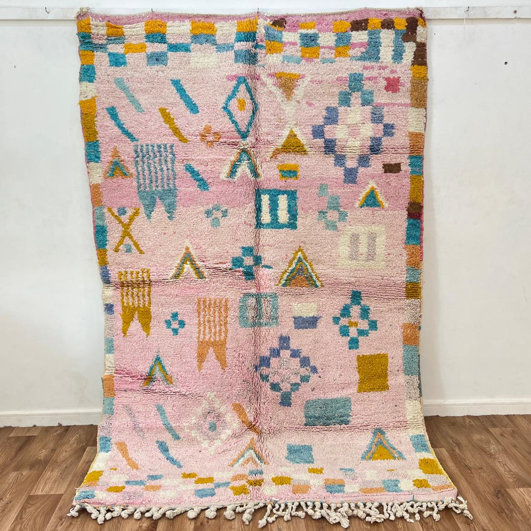 Vintage Moroccan wool rug 202 – handmade Berber rug with pastel pink, yellow, and blue geometric patterns (236 × 160 cm).