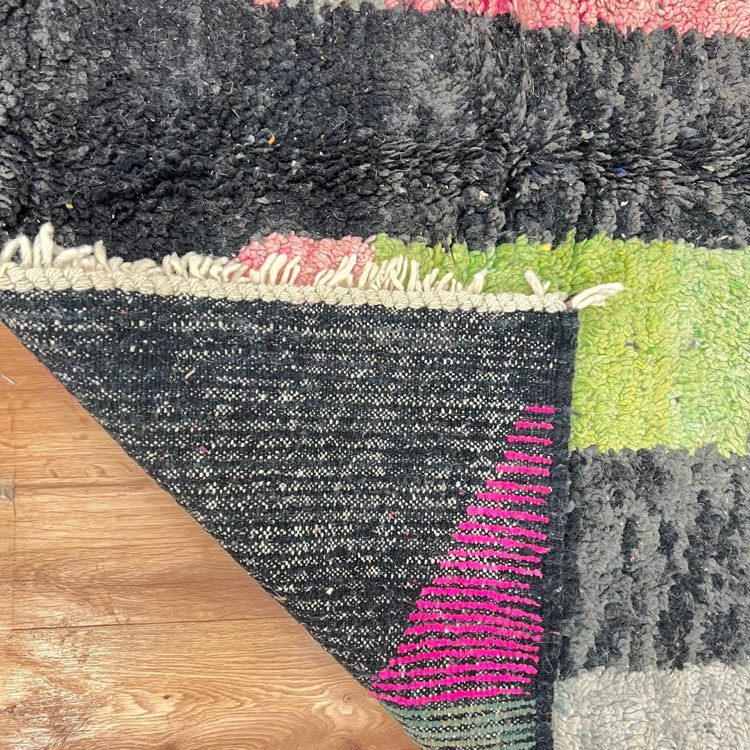 Vintage Moroccan wool rug 731 – handmade Berber carpet with black, green, pink, and grey abstract tribal patterns (233 × 147 cm / 7.64 × 4.82 ft).