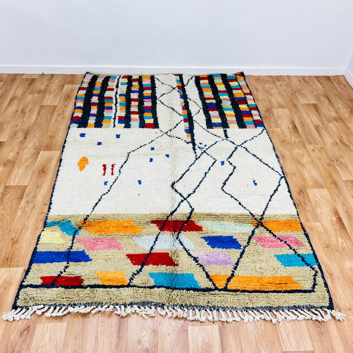 Vintage Moroccan Berber wool rug with ivory base, black tribal lines and colorful geometric accents