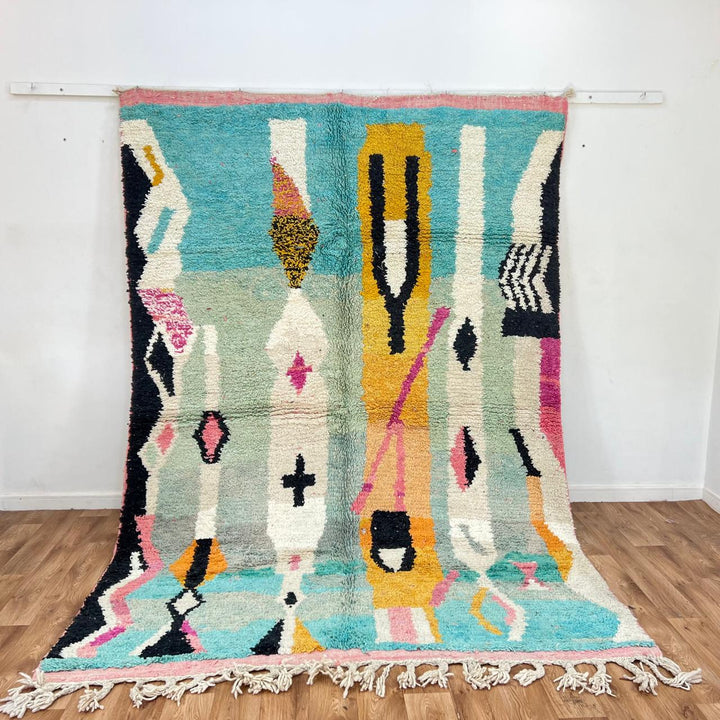 Vintage Moroccan wool rug 857 – handmade abstract Berber carpet in turquoise, black, pink, and mustard tones (290 × 205 cm / 9.51 × 6.72 ft).
