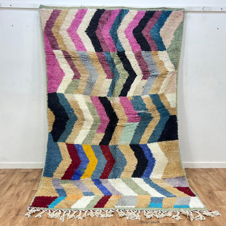 Vintage Moroccan wool rug 773 – colorful handmade Berber carpet with zigzag chevron patterns in blue, pink, yellow, and cream, 264 × 164 cm (8.66 × 5.38 ft).