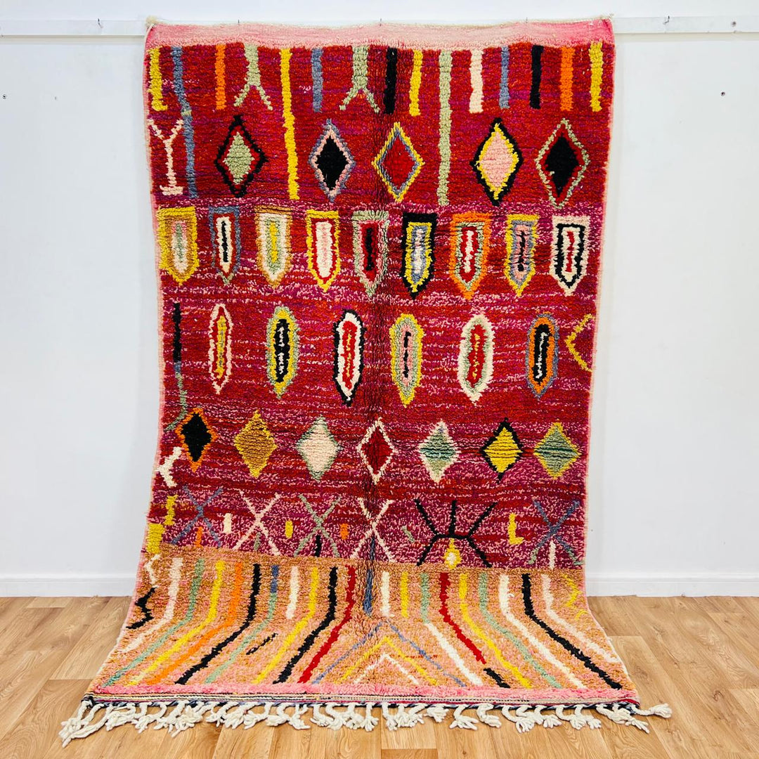 Vintage Moroccan wool rug with red base, colorful Berber diamond patterns, handmade tribal carpet
