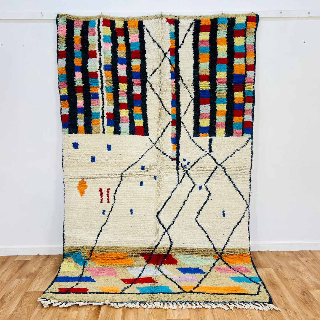 Vintage Moroccan Berber wool rug with ivory base, black tribal lines and colorful geometric accents