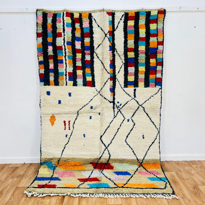 Vintage Moroccan Berber wool rug with ivory base, black tribal lines and colorful geometric accents