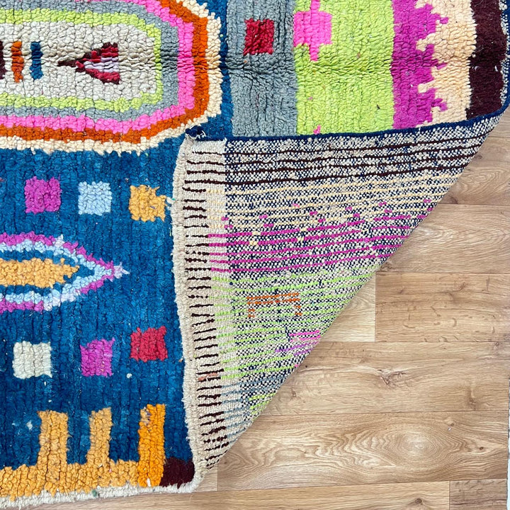 Vintage Moroccan wool rug 138 – handmade colorful geometric Berber design with pink, blue, and orange tones (234 × 162 cm).