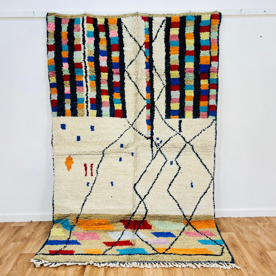 Vintage Moroccan Berber wool rug with ivory base, black tribal lines and colorful geometric accents