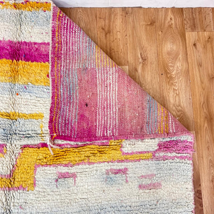 Vintage Moroccan wool rug 207 – handmade minimal abstract design in cream, pink and yellow (263 × 154 cm).