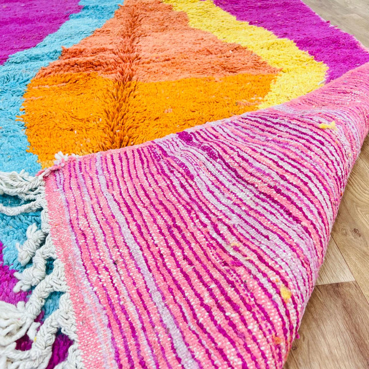 Vintage Moroccan wool rug with pink base, turquoise, orange and yellow abstract Berber design, handmade in Morocco, size 255x156 cm
